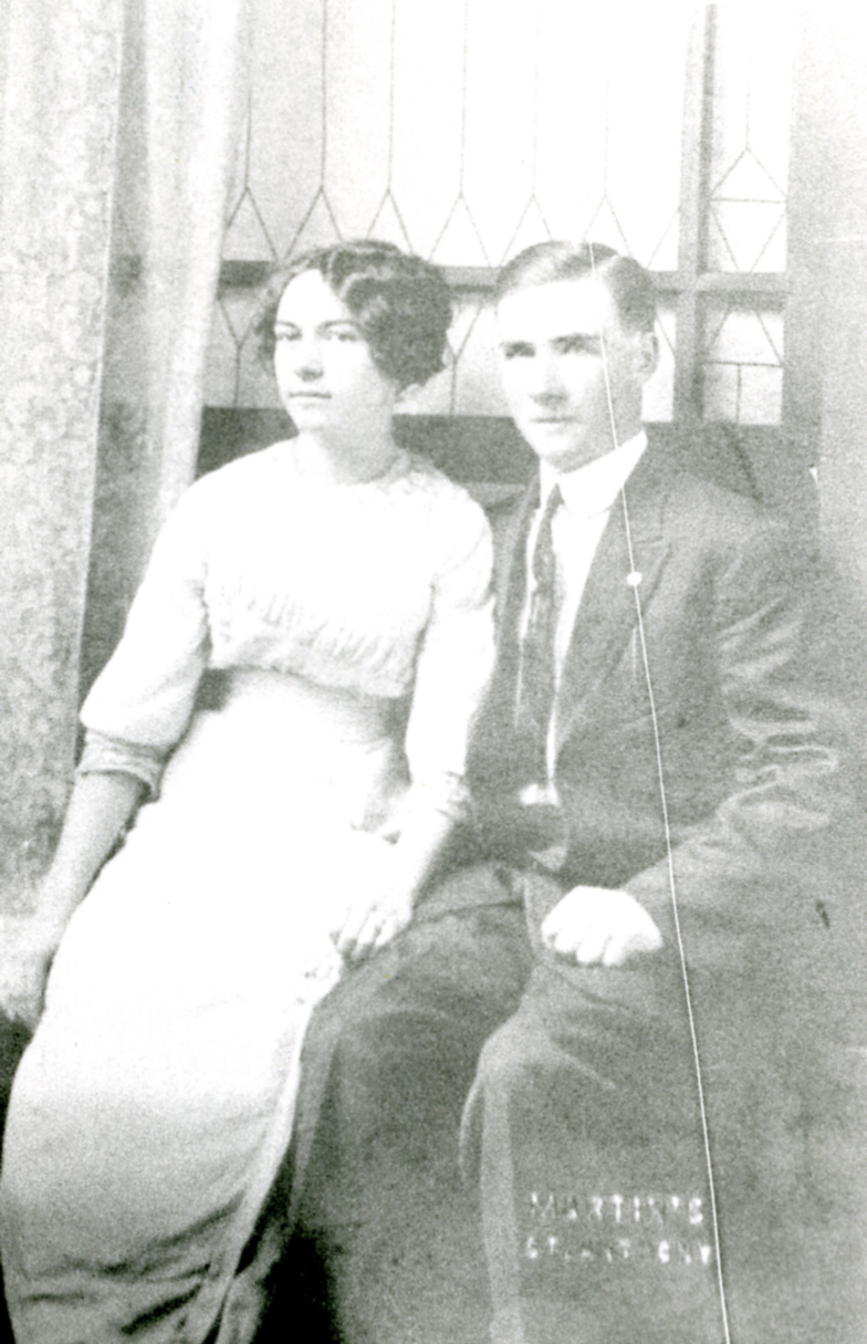 black and white pograph of a man and woman seated on couch