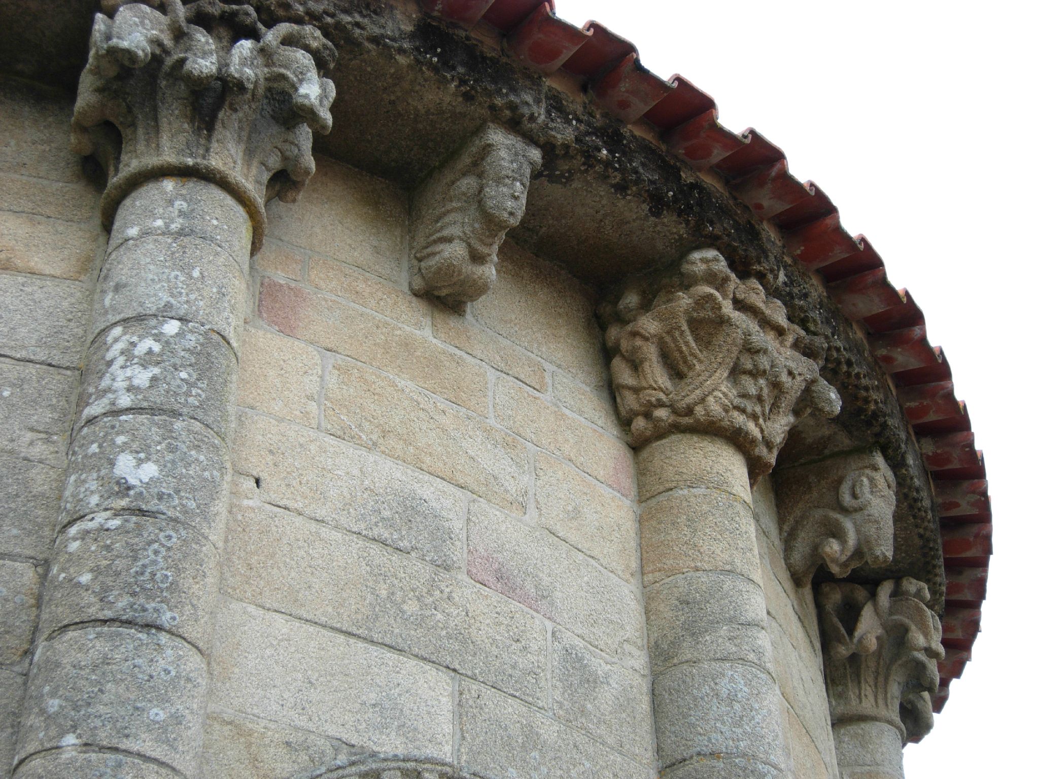 two stone pillars with intricate carvings on top of them