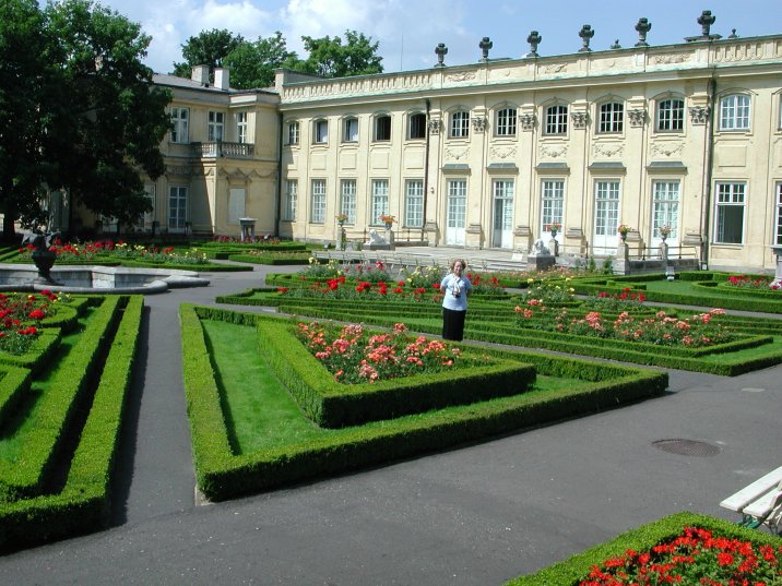 a woman is in the middle of an ornamental garden