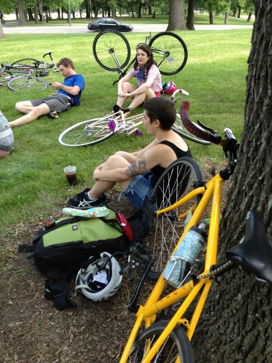 a group of people sitting around with bikes on them