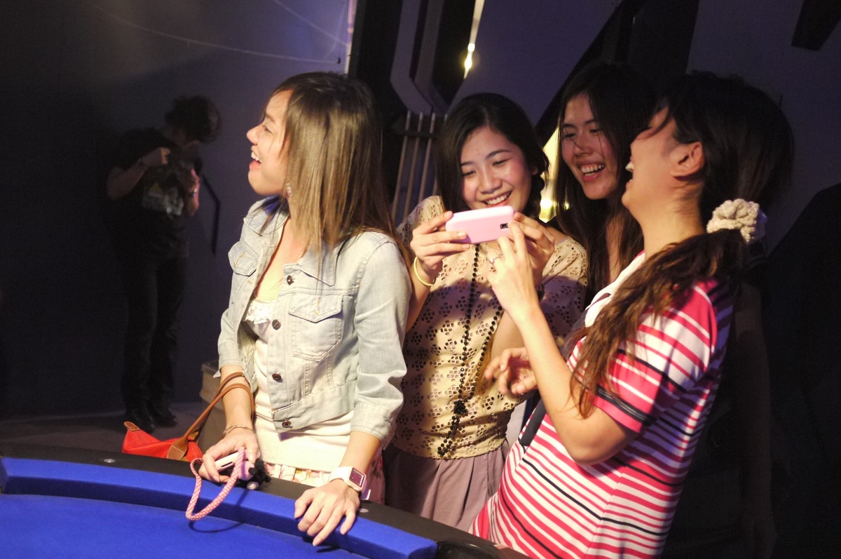 young women are smiling and playing poker