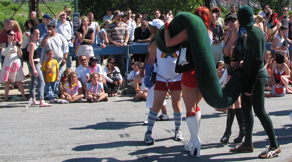 a couple of men are hugging and being hugged by other people