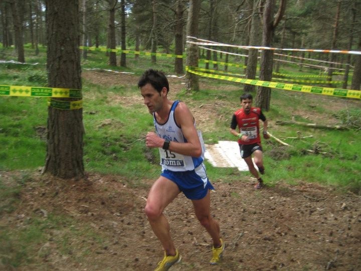 two men are running in the woods together