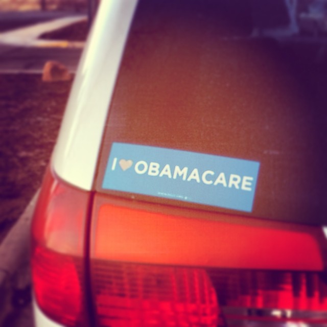an obama bumper sticker on the tail end of an older car