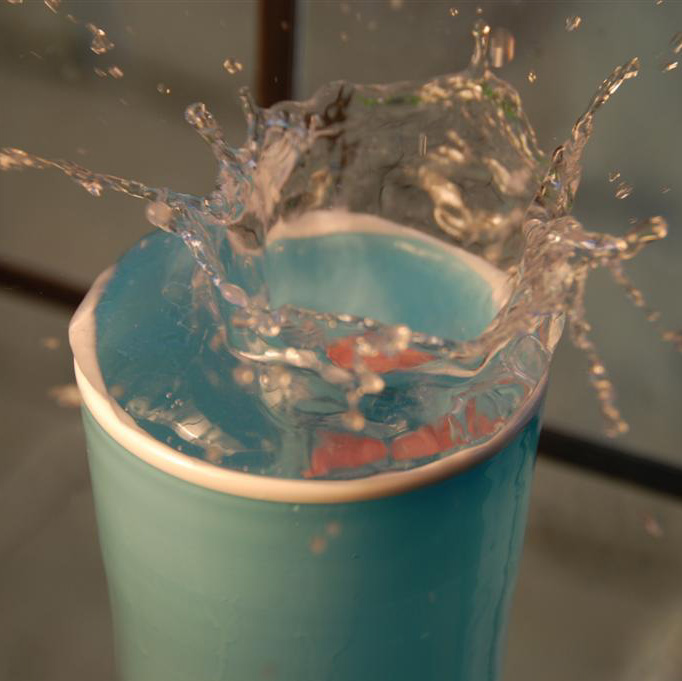 a blue cup with water and orange slices