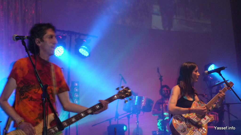 man and woman playing instruments on stage at concert