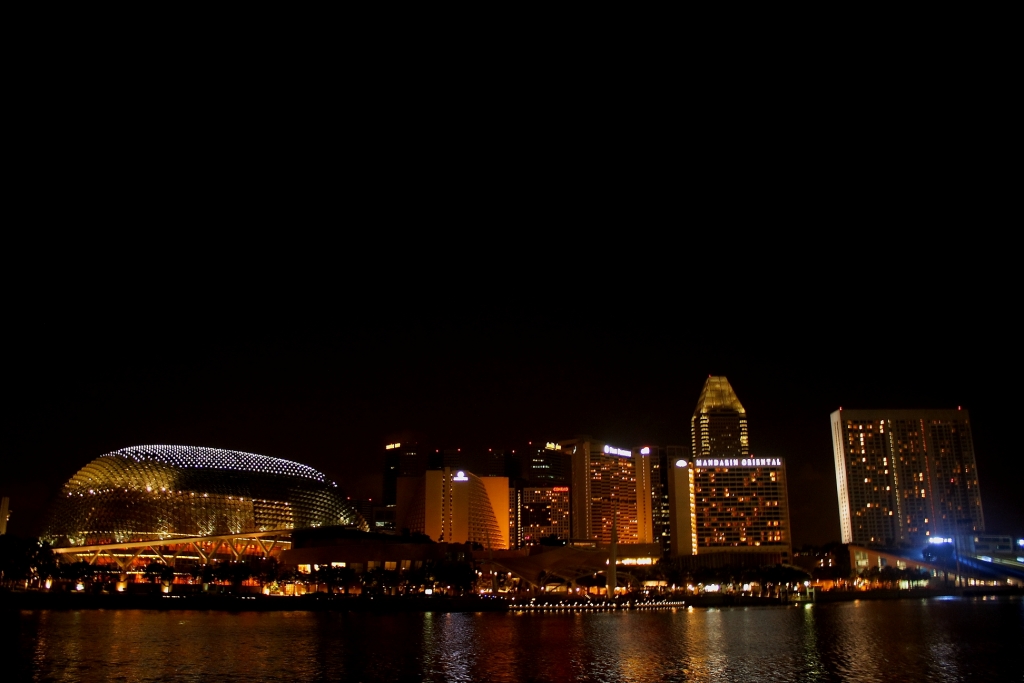 a very tall building next to a body of water