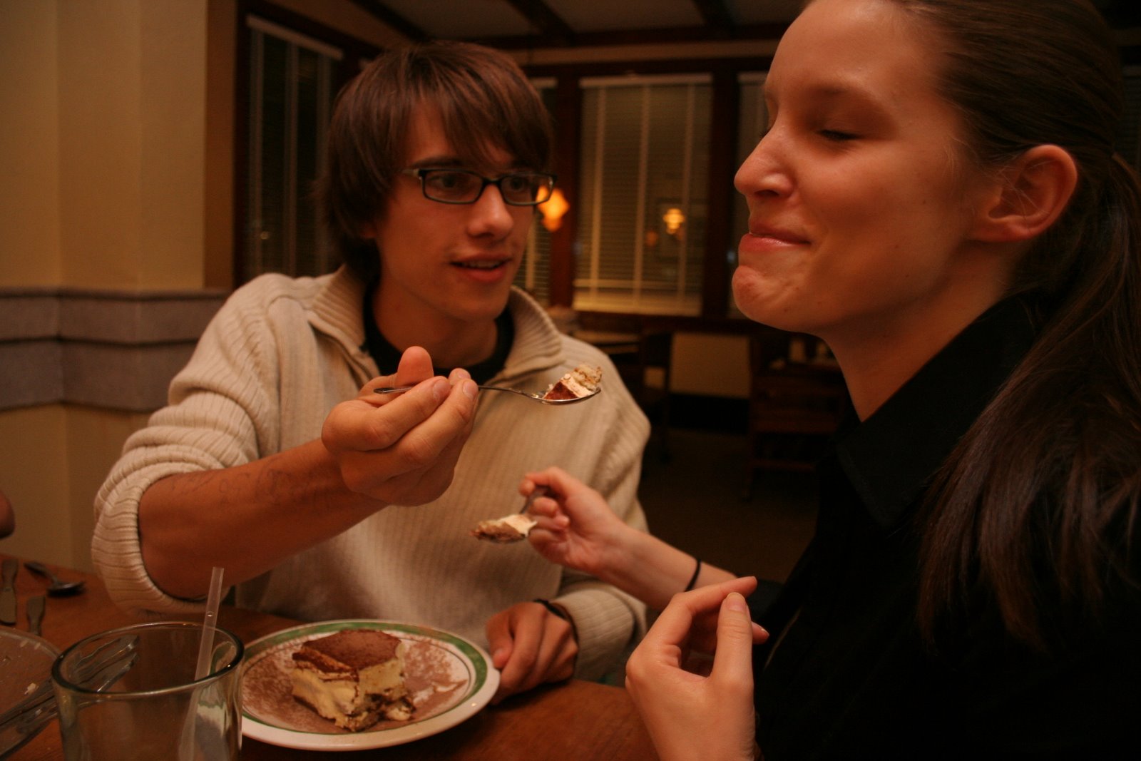 a woman with glasses is eating some food