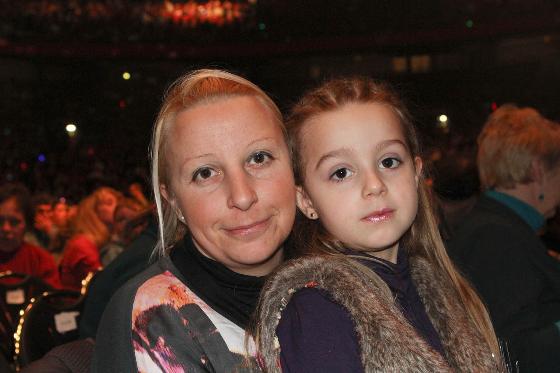 a woman and a child standing together in a theater