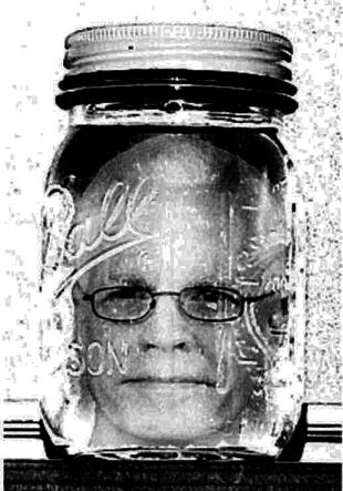 an old black and white po of a woman with a jar on her head