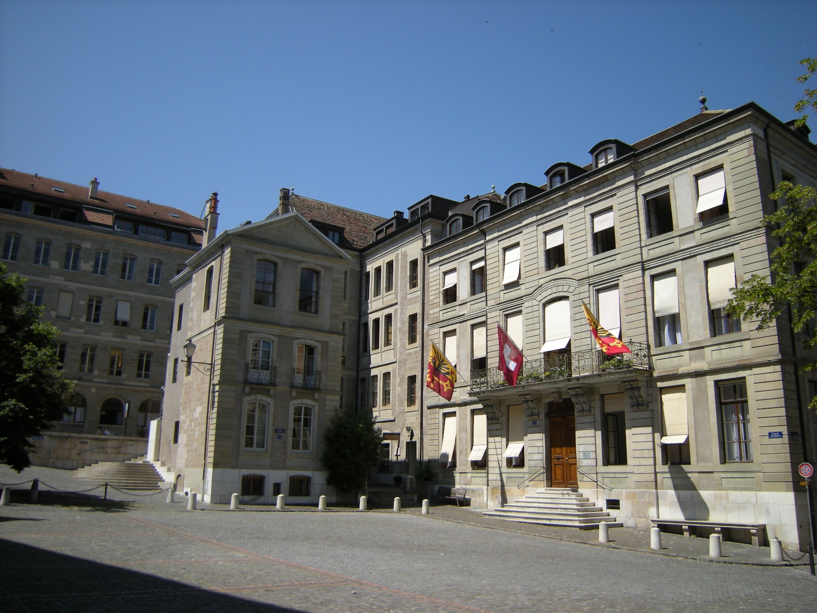 two buildings with multiple balconies and flags hanging on them