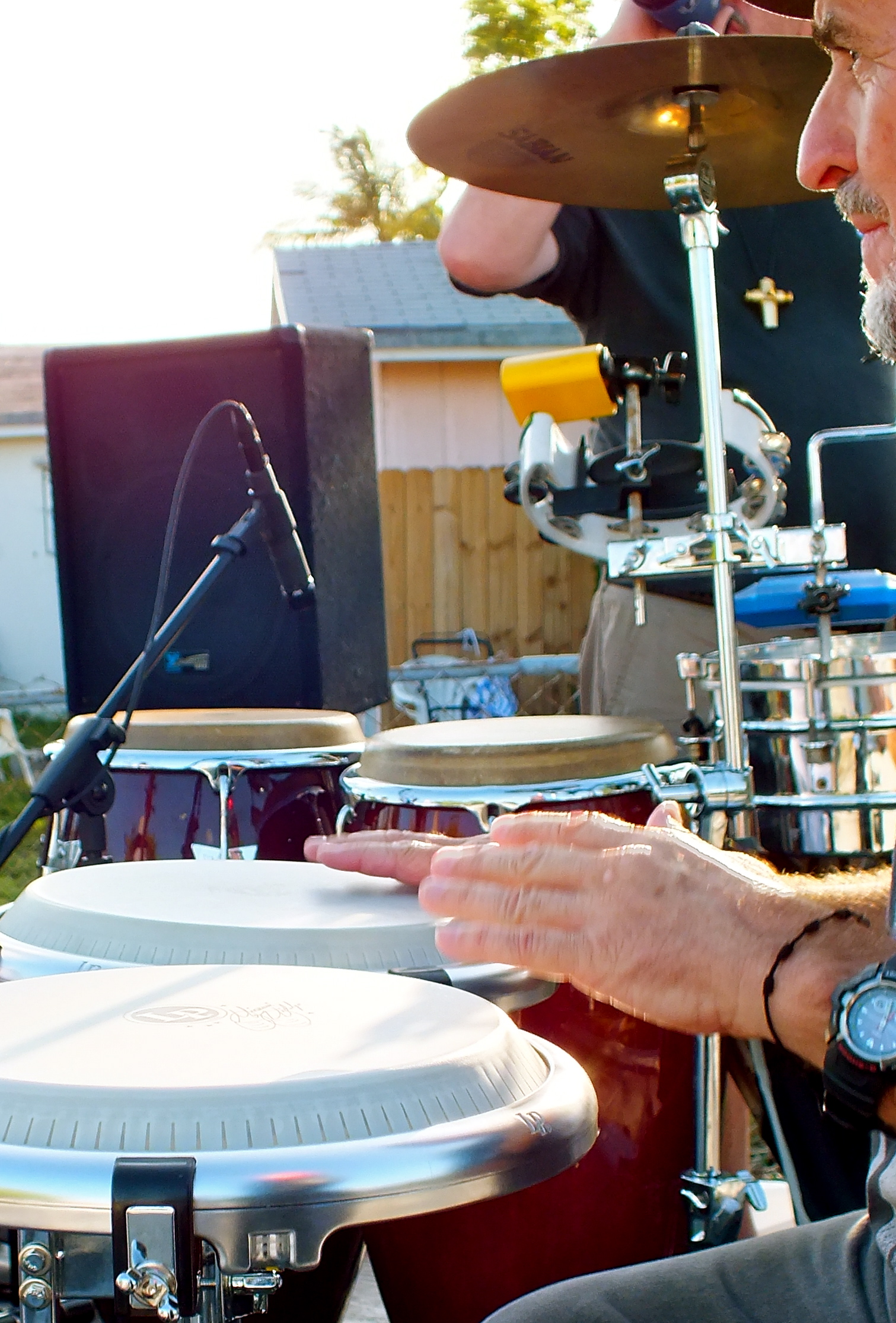 a man standing in front of a drum kit