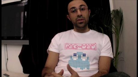 a man wearing a t shirt with an old arcade video game on it