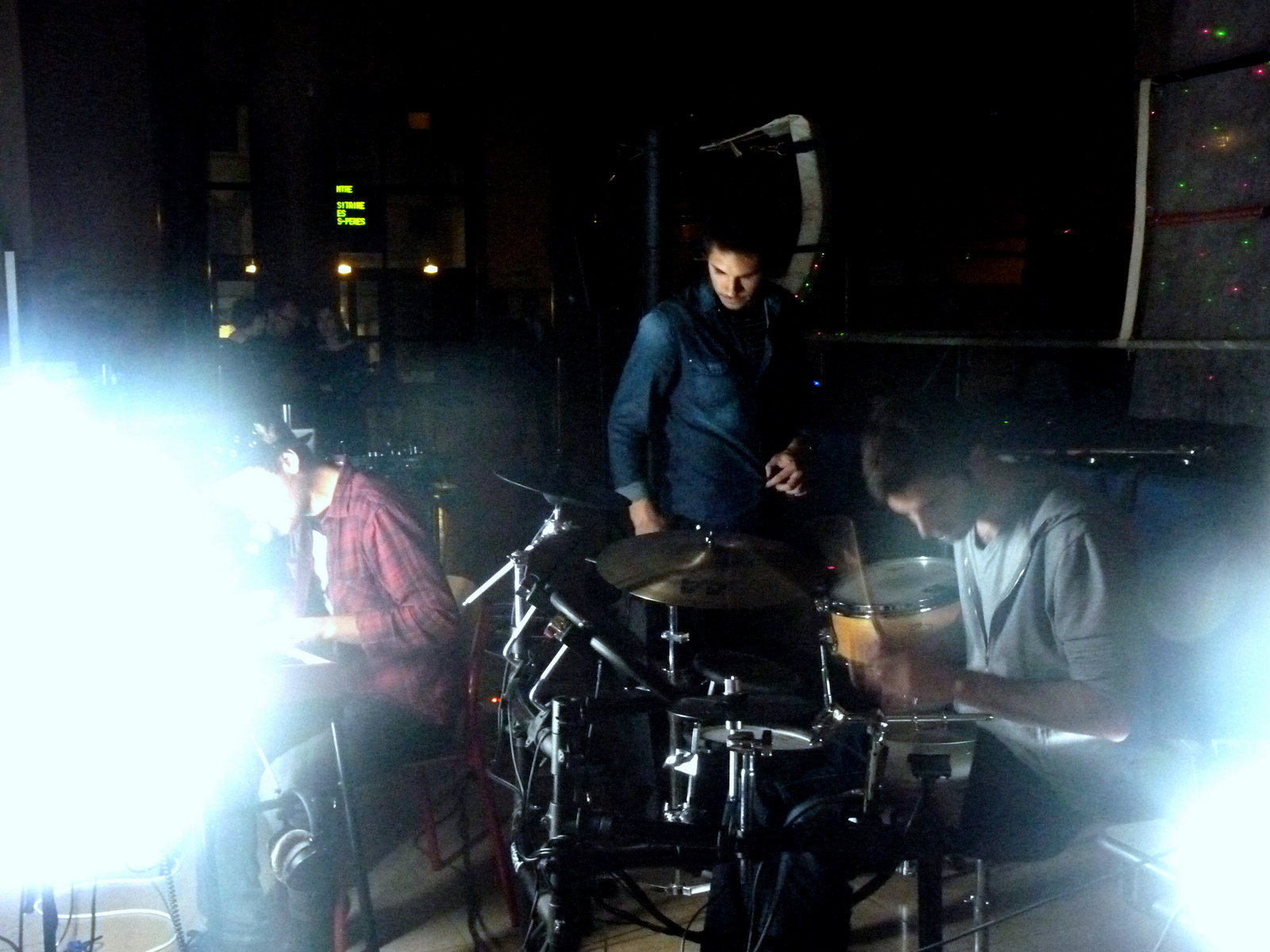 the drum player sits in front of his band