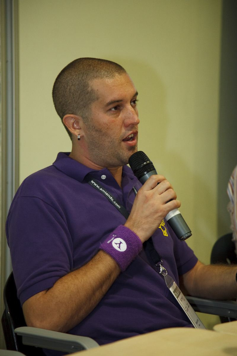 a man in purple holding up a microphone