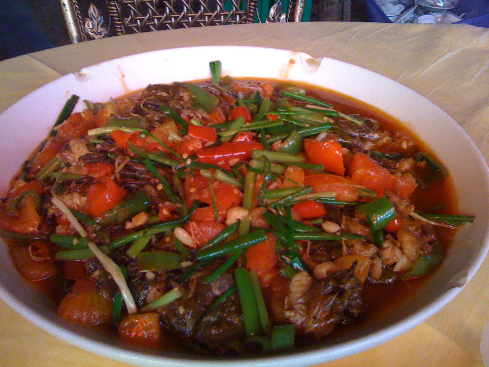 a white bowl full of beef, green beans and carrots