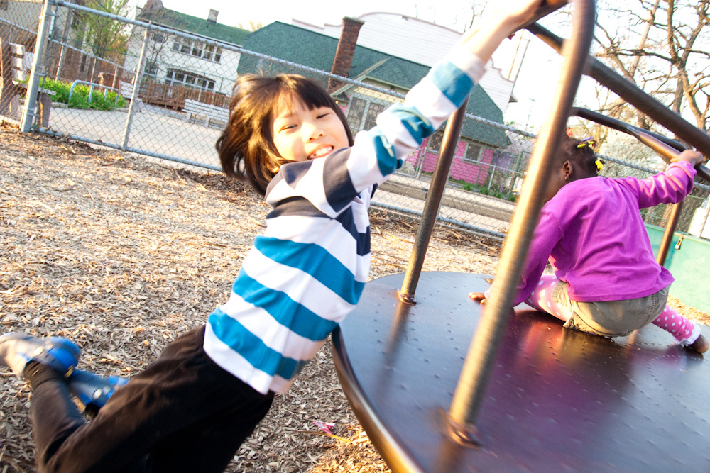 a small child is climbing on a playground slide