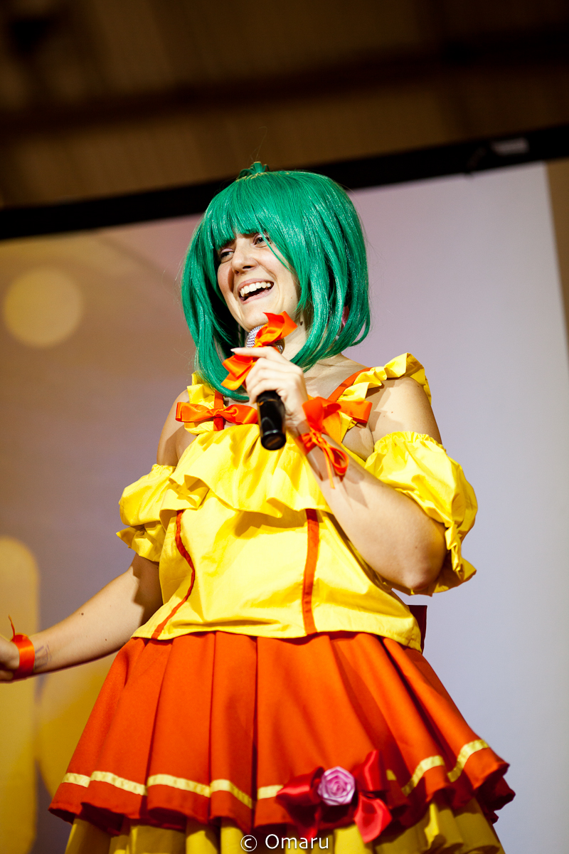a female singer is smiling in colorful clothes