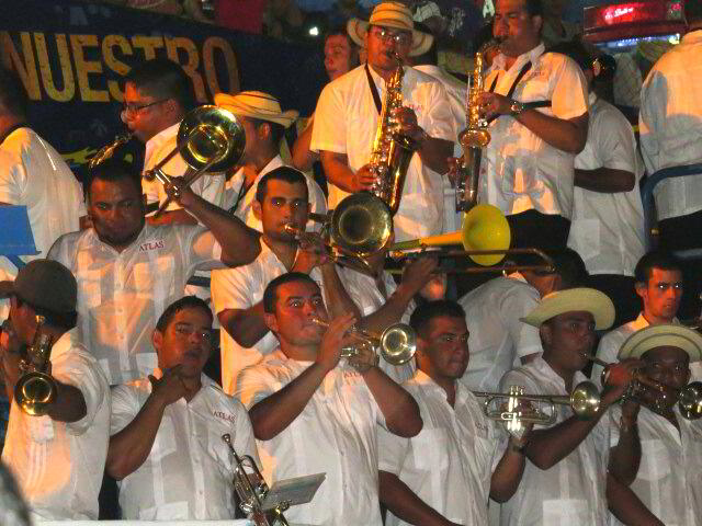 the men are all dressed in white and playing instruments