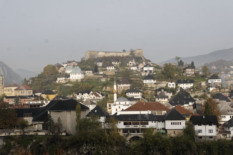 a city with lots of houses sitting on a hillside