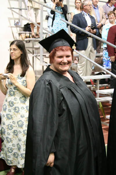 the woman is in her graduation cap and gown