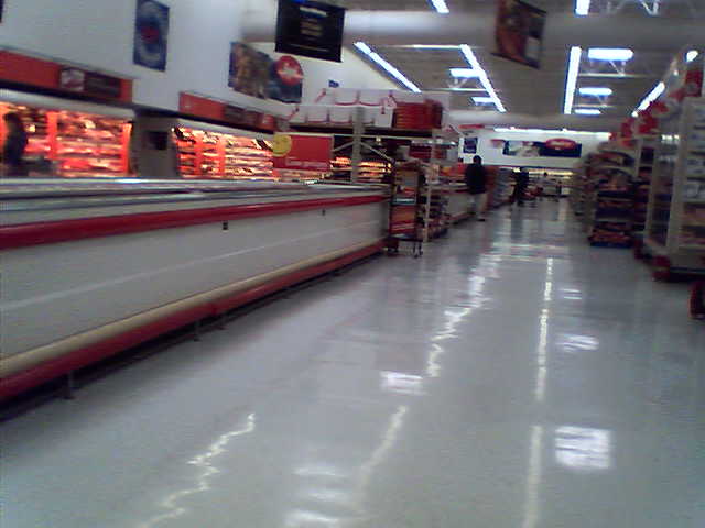 the grocery store aisle is empty and it has no customers