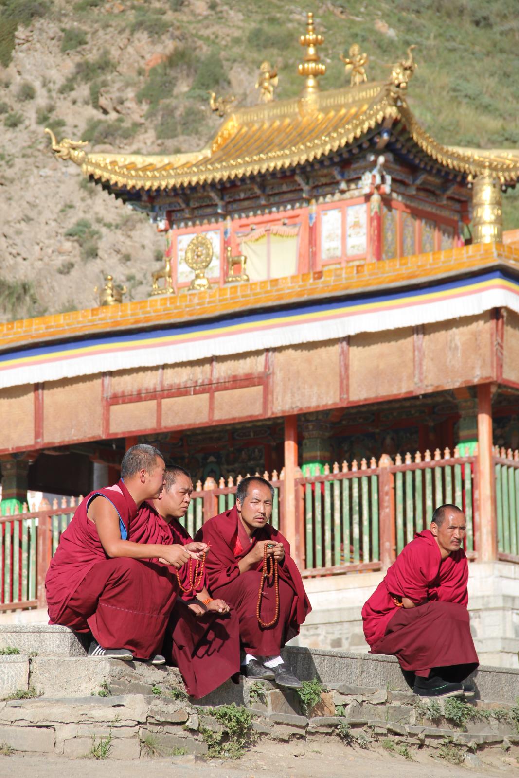 some people in red clothes are sitting outside