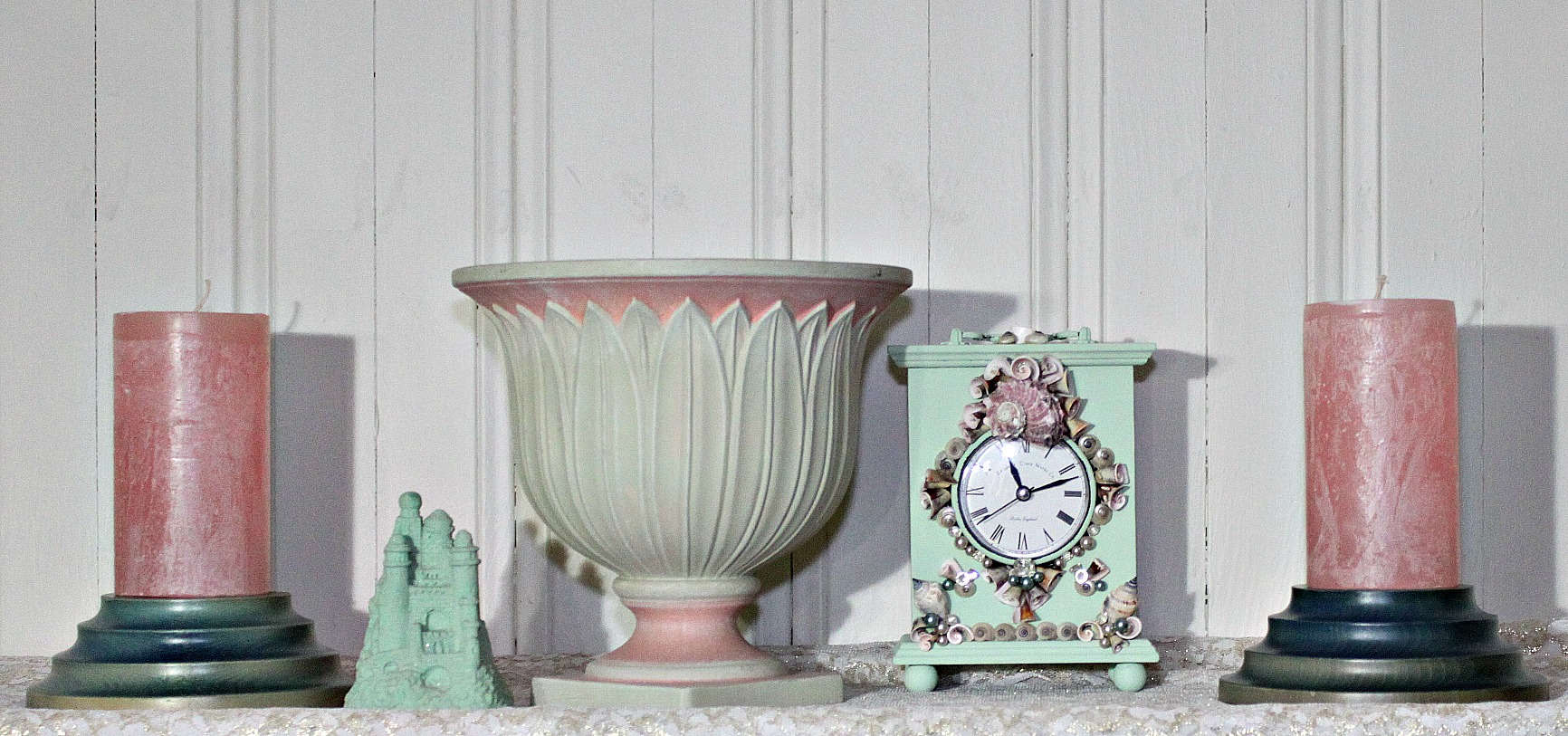 a clock next to a clock and several decorative vases