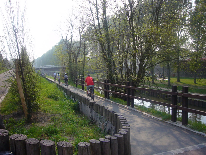 the group is riding their bikes on the path