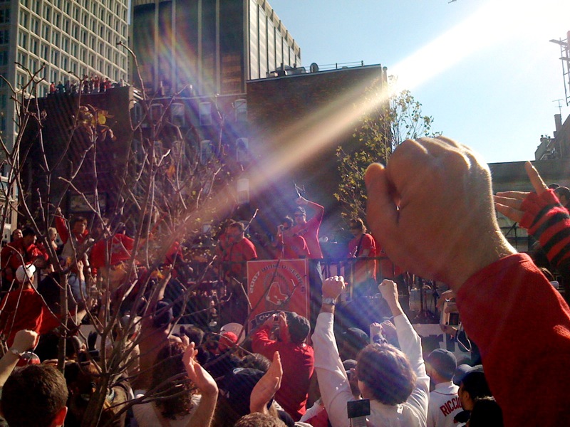 a crowd of people taking pictures and waving