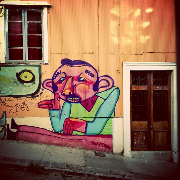 an old building painted with graffiti and the street in front