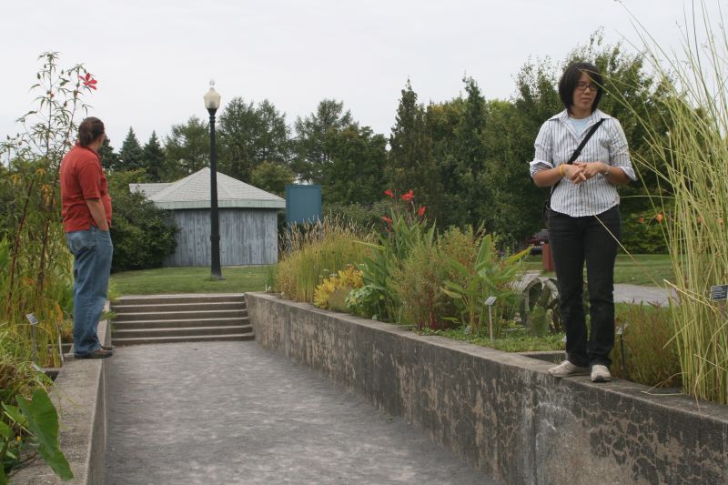 two people standing by the path and grass