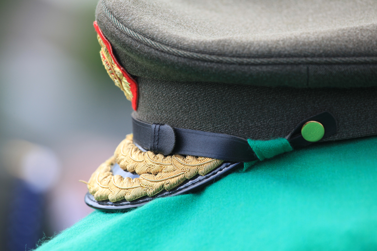 military officer in green uniform standing outdoors
