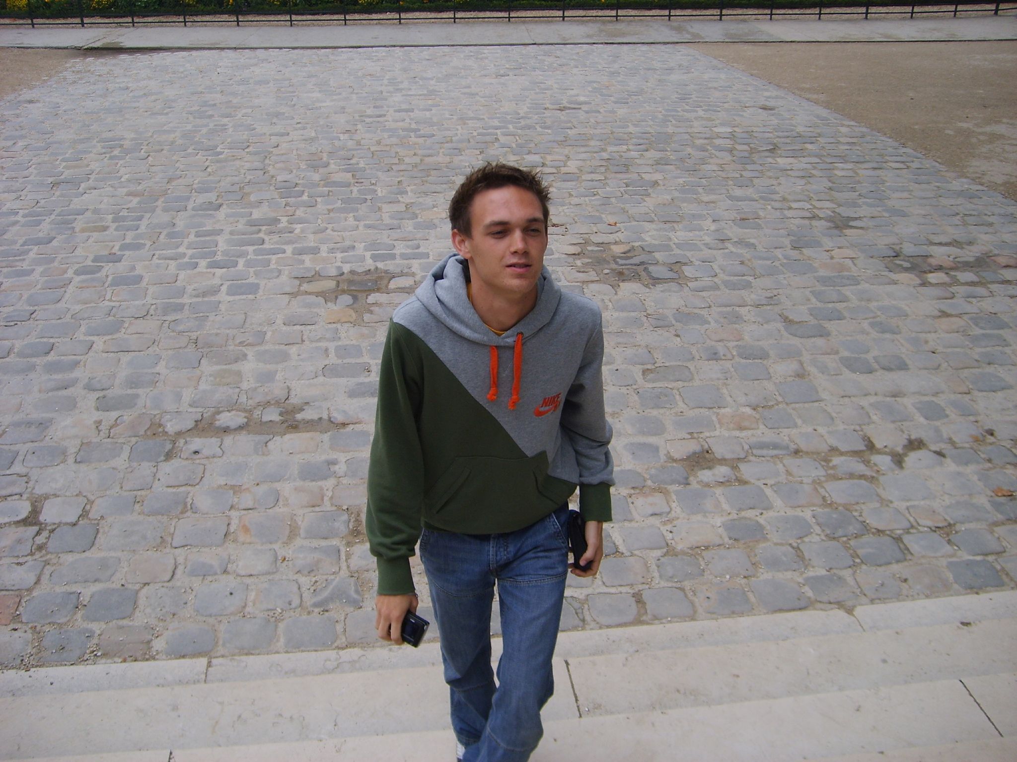 a young man walking up some steps towards the camera