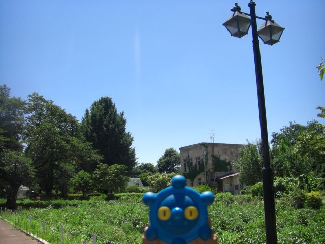 a statue of a blue and orange object stands on a street