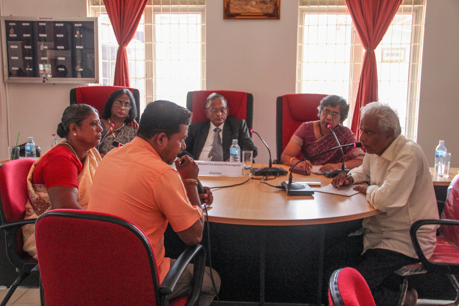 a group of people sitting around a conference table