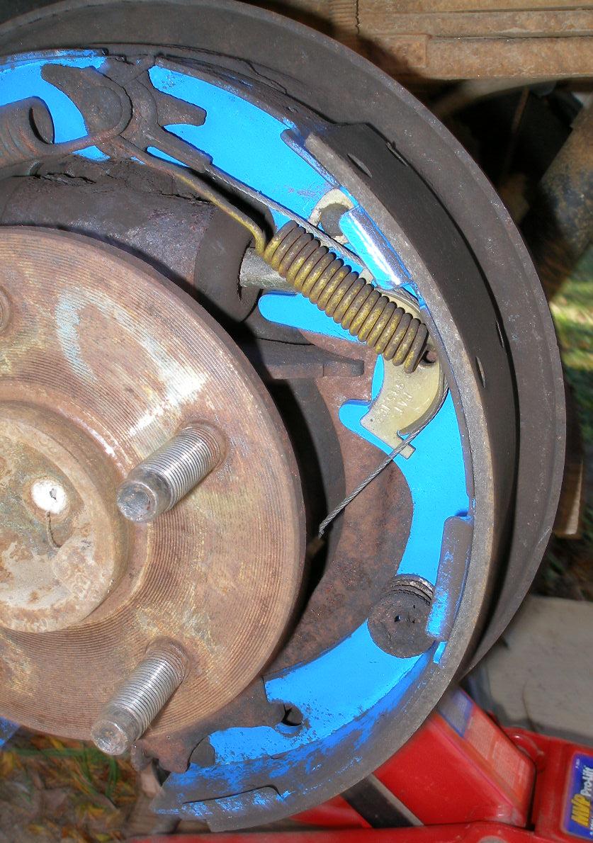 the top of a metal disc is visible with metal pins and nails