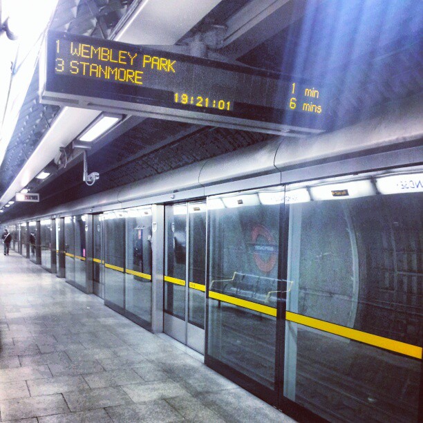 a train stopped on the platform with a sign stating that the subway is starting to move in