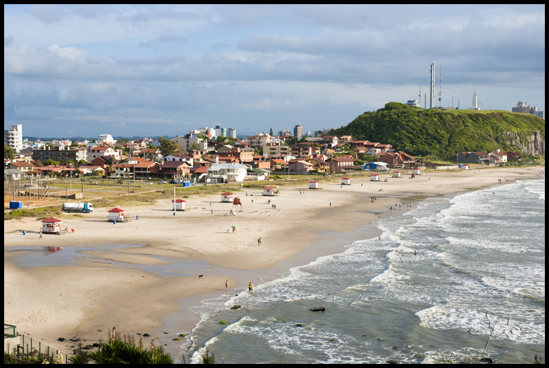 the view of an aerial city and beach from a helicopter