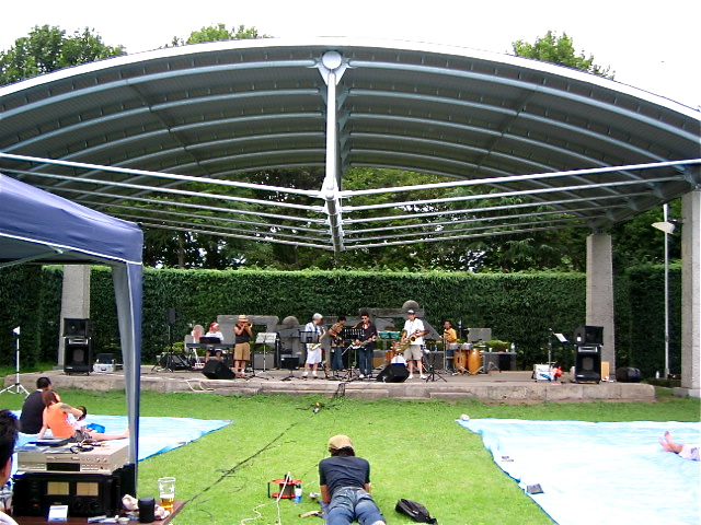 a concert setting with the band and the musicians on stage