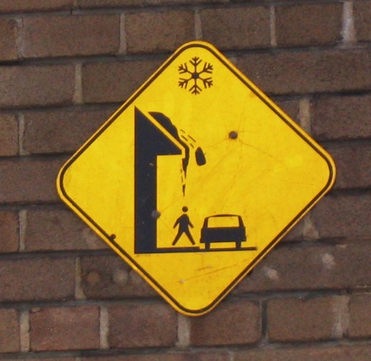 a yellow sign is shown on a brick wall