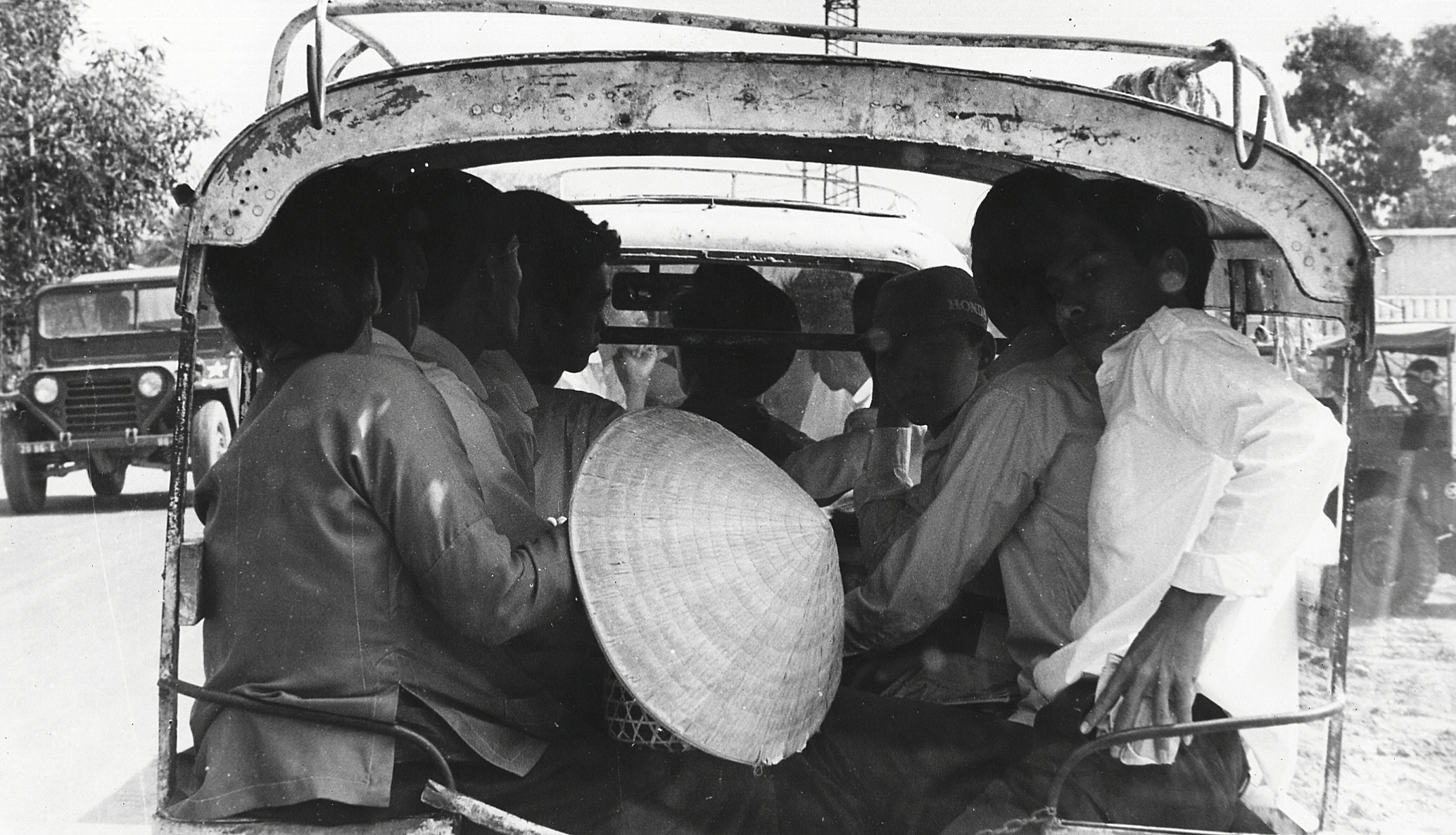 a group of men riding in the back of a truck