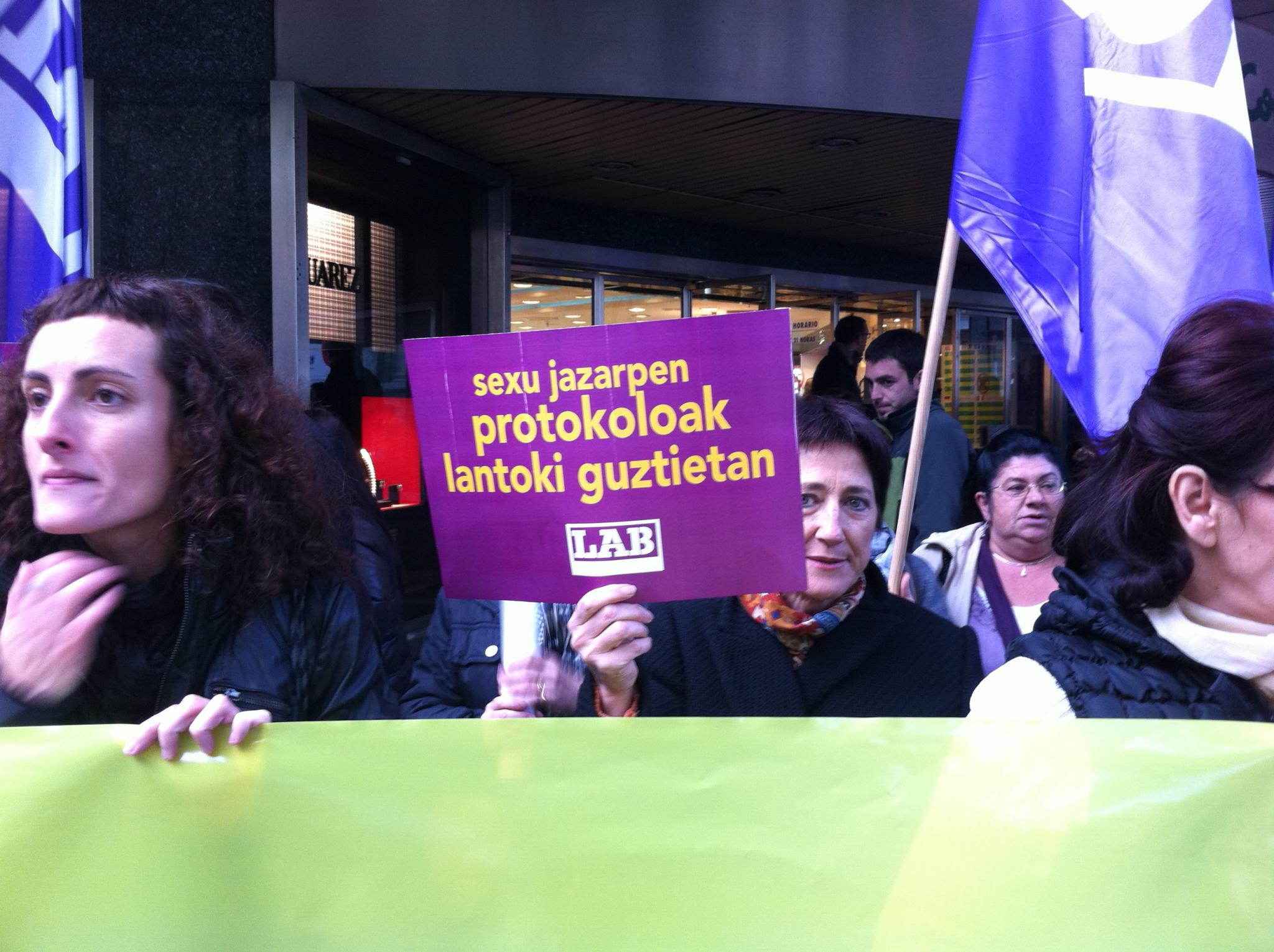 there are women holding signs with flags at a protest