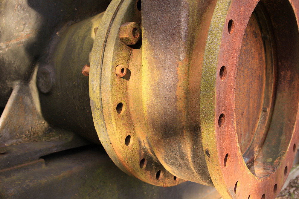 a rusted metal item on the side of a train