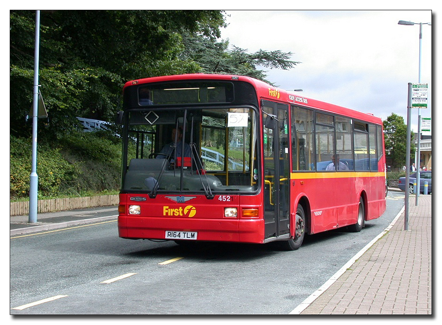 a large long red bus on the street