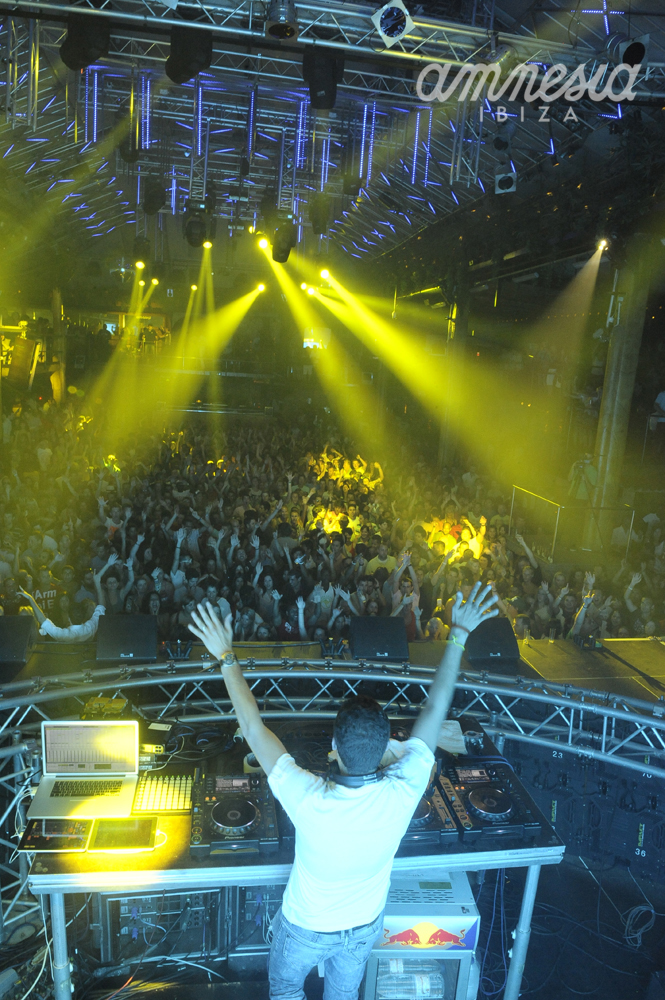 the dj in front of a crowd is having fun