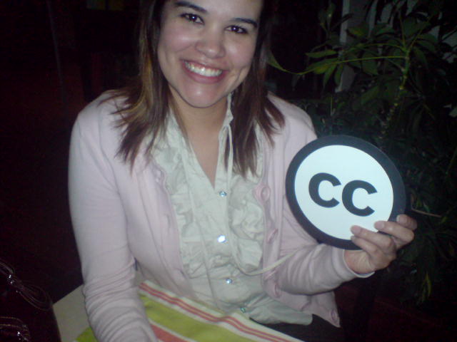a woman smiling with a plate with the letter c written on it