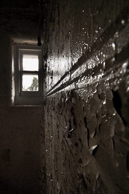 light shining from a window in an abandoned building