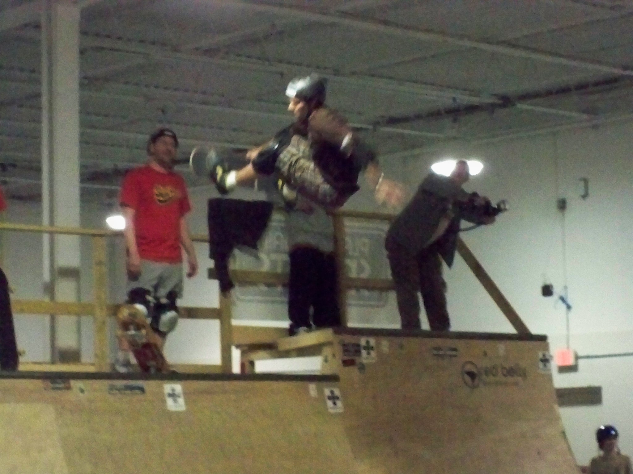 skateboarder jumping in the air on top of the ramp