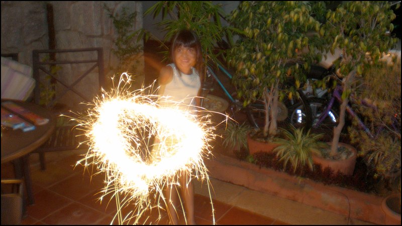 a young person with fireworks in their hand